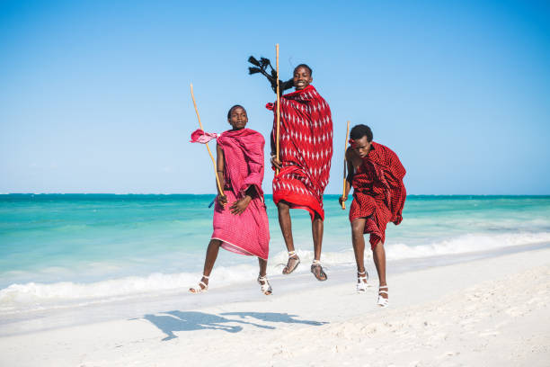 Masai warriors jumping on  a beautiful African beach (Zanzibar, Tanzania),